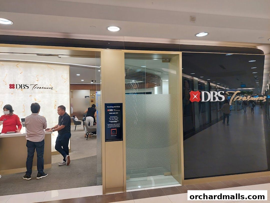 The entrance of DBS Treasures Ngee Ann City bank branch with staff and customers.