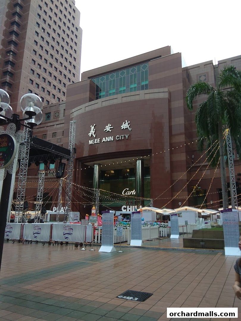 Ngee Ann City mall exterior with festive lights and stalls set up outside.
