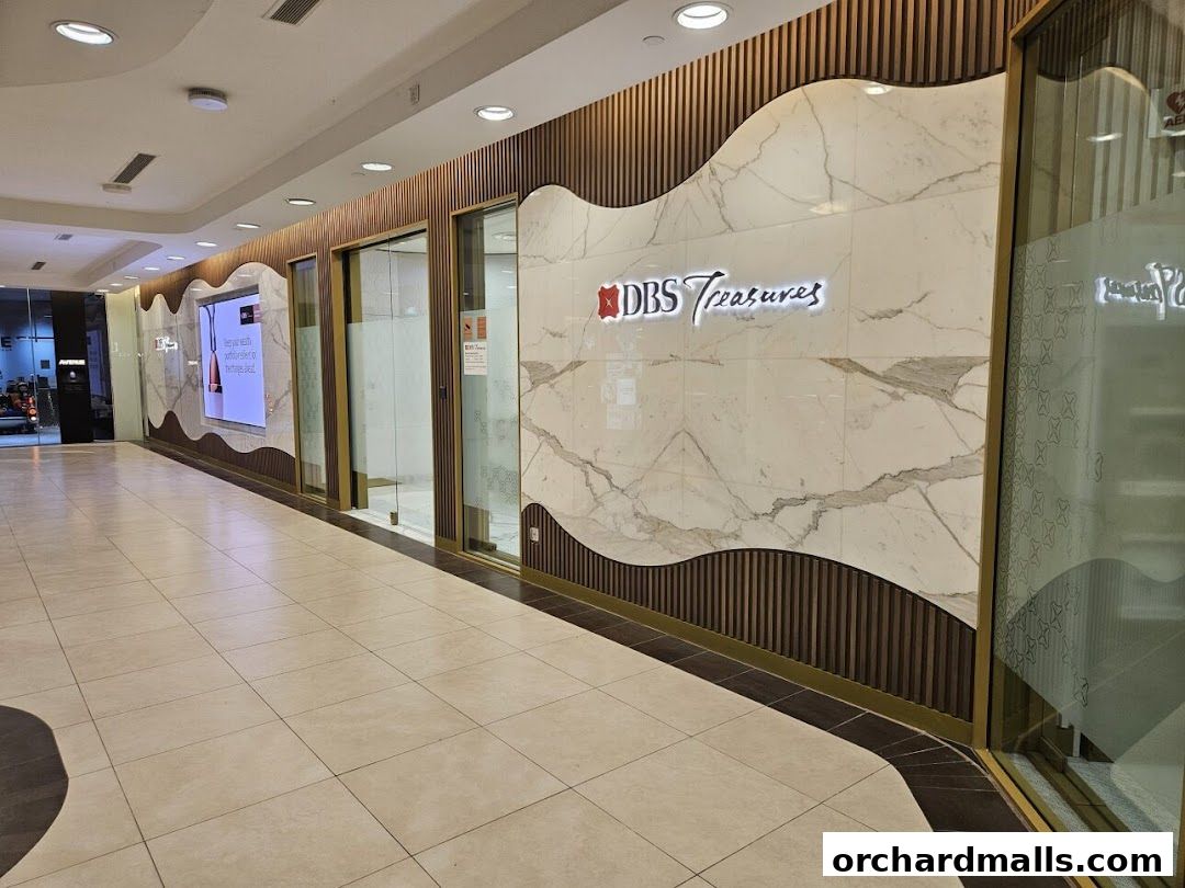 The exterior of the DBS Treasures Ngee Ann City bank branch with elegant marble and wood paneling.