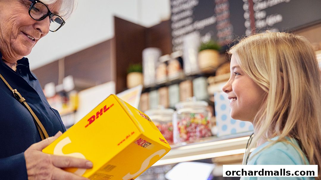A woman hands a DHL package to a smiling girl in a shop.