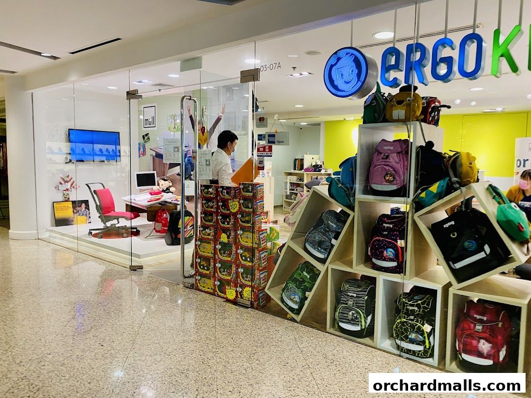 Ergo Kid store front displaying ergonomic chairs and a variety of backpacks.