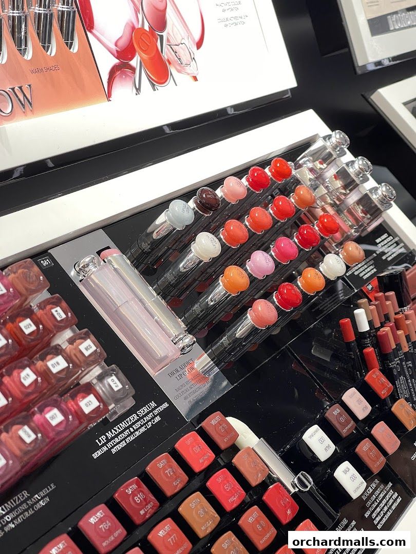 A display of various Dior lip products, including lip maximizers and lip glows in multiple shades.