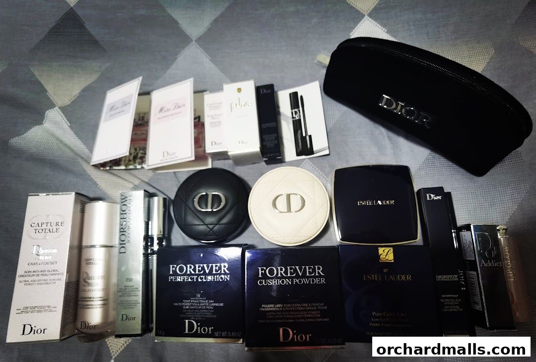 A collection of Dior and Estee Lauder beauty products, including foundations, lipsticks, and makeup samples.