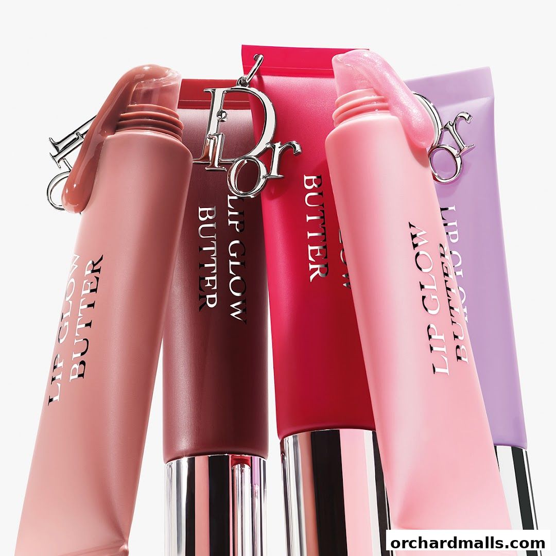 Close-up of four Dior Lip Glow Butter tubes in various shades with the Dior logo.