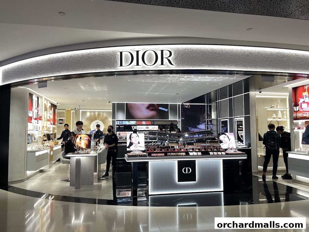 The Dior Beauty boutique showcases a wide array of makeup products and displays, with staff attending to customers.