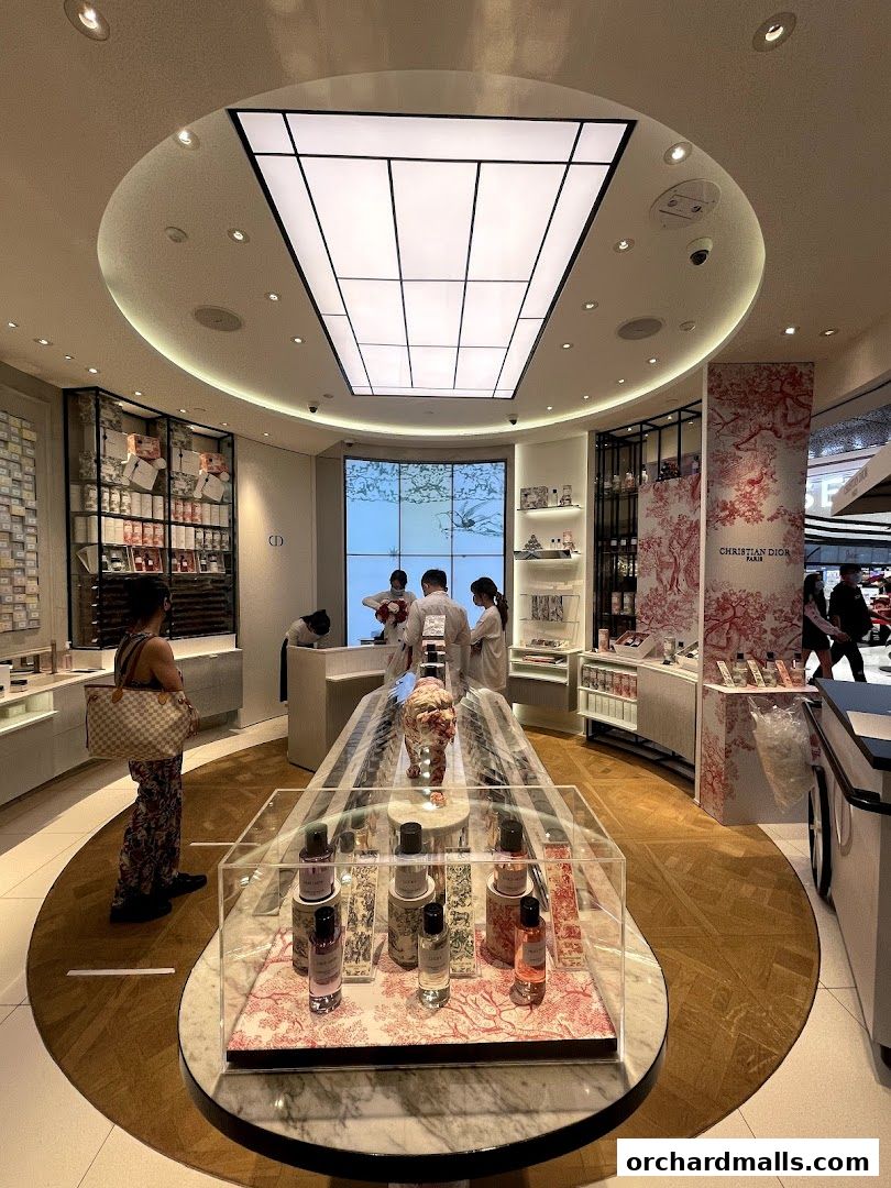 Interior of a Dior Beauty boutique showcasing fragrances and beauty products with staff assisting customers.