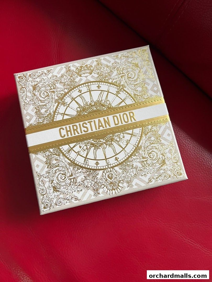 A beautifully designed Dior gift box with intricate gold patterns and the Christian Dior logo.