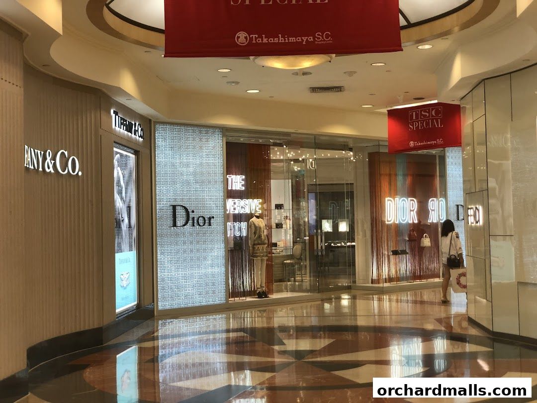 The Dior and Tiffany & Co. storefronts in a shopping mall with reflective floors.
