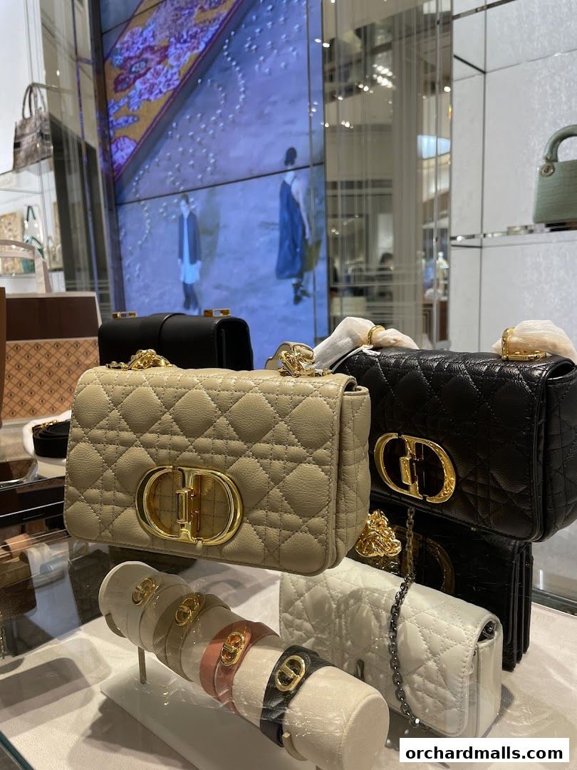 Dior handbags and bracelets displayed in a luxury retail store.