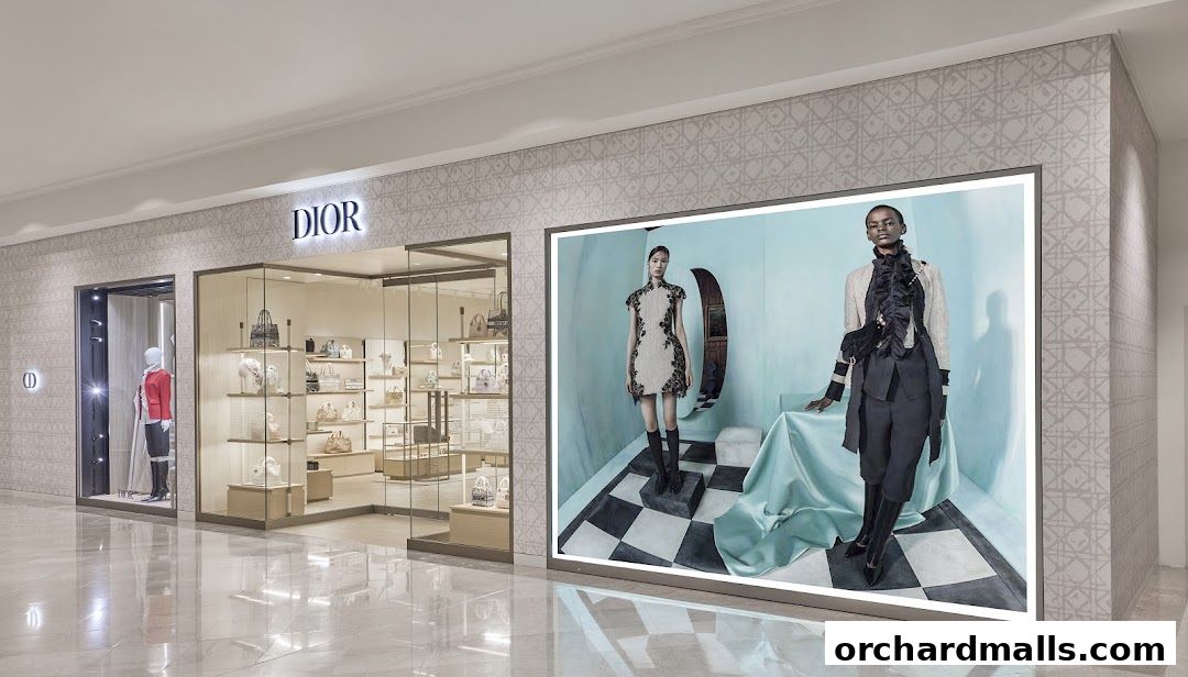 Dior Ngee Ann City store front with mannequins and a large advertising display.
