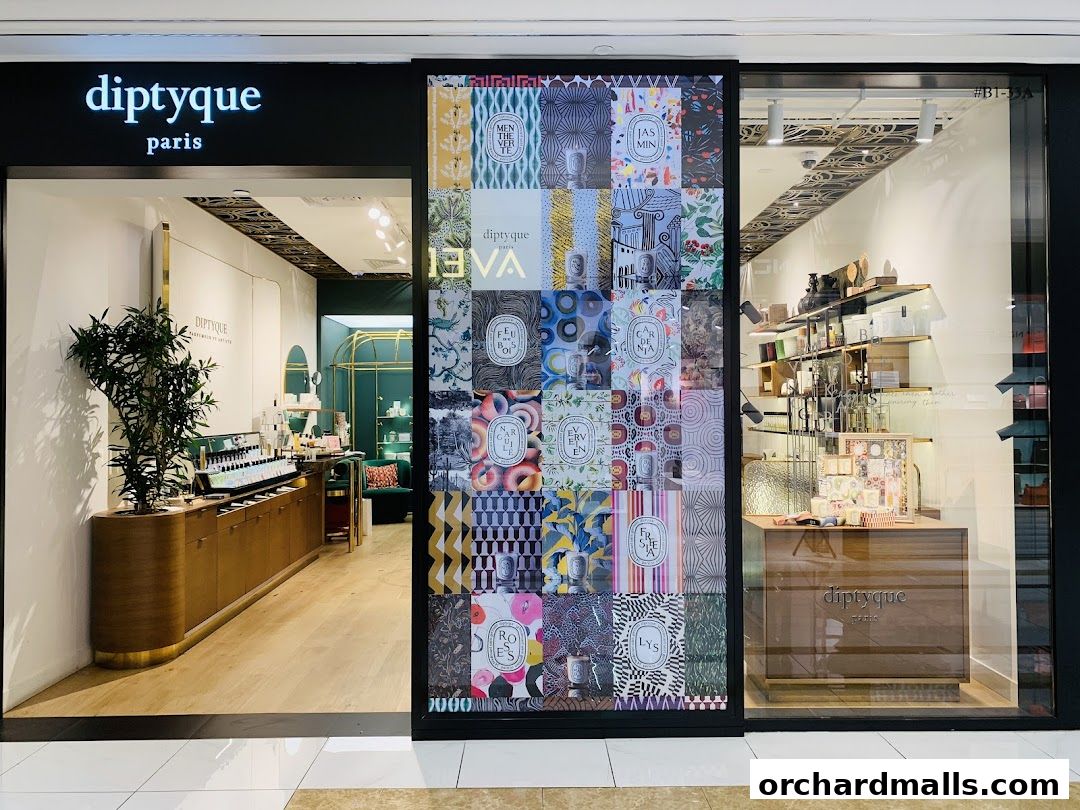 The entrance of a Diptyque Paris boutique showcasing perfumes and home fragrances.