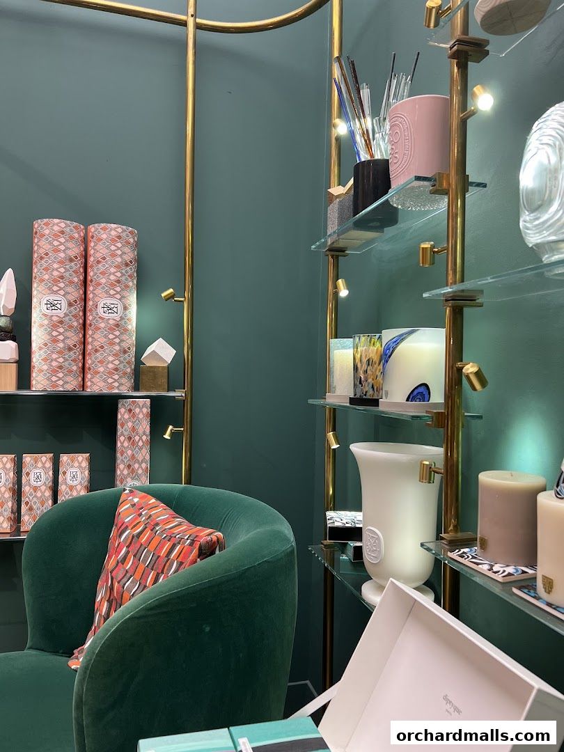 A luxurious interior of a Diptyque shop featuring candles and diffusers.