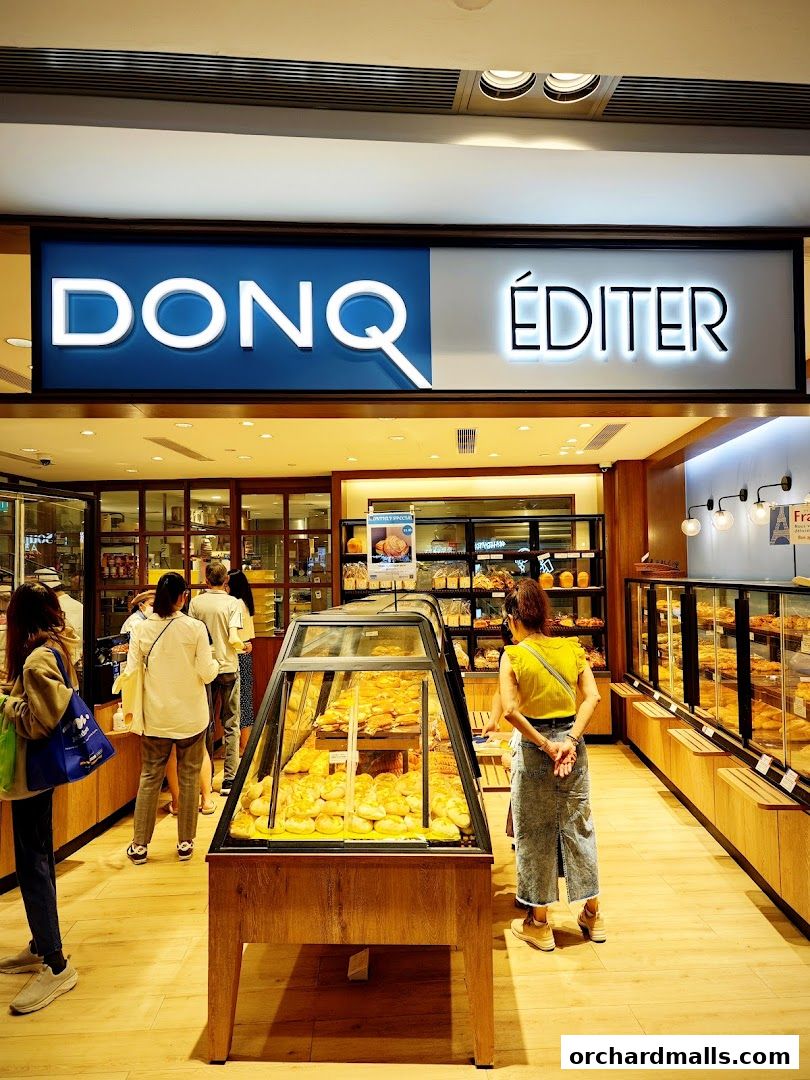 Interior of a bakery with display cases filled with fresh bread and pastries.