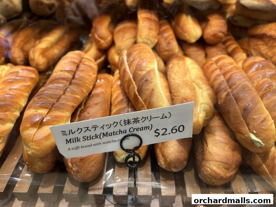 A close-up view of freshly baked milk sticks filled with matcha cream.