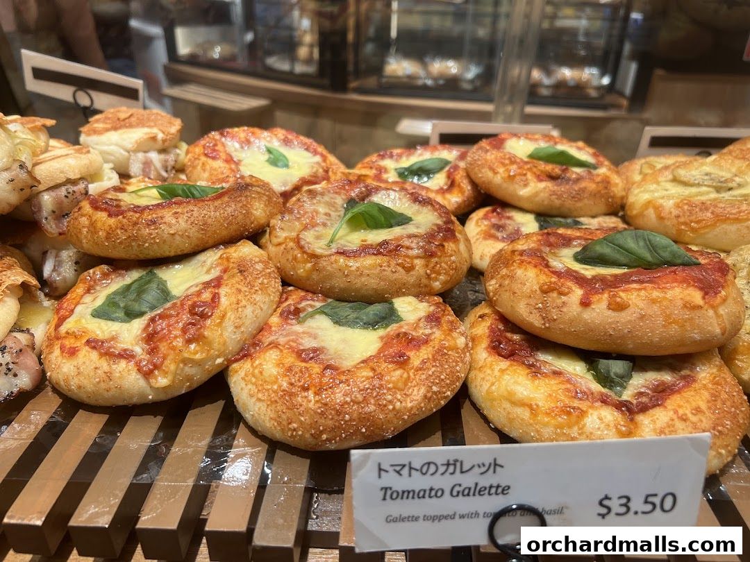 A close-up of delicious tomato galettes topped with cheese and basil.