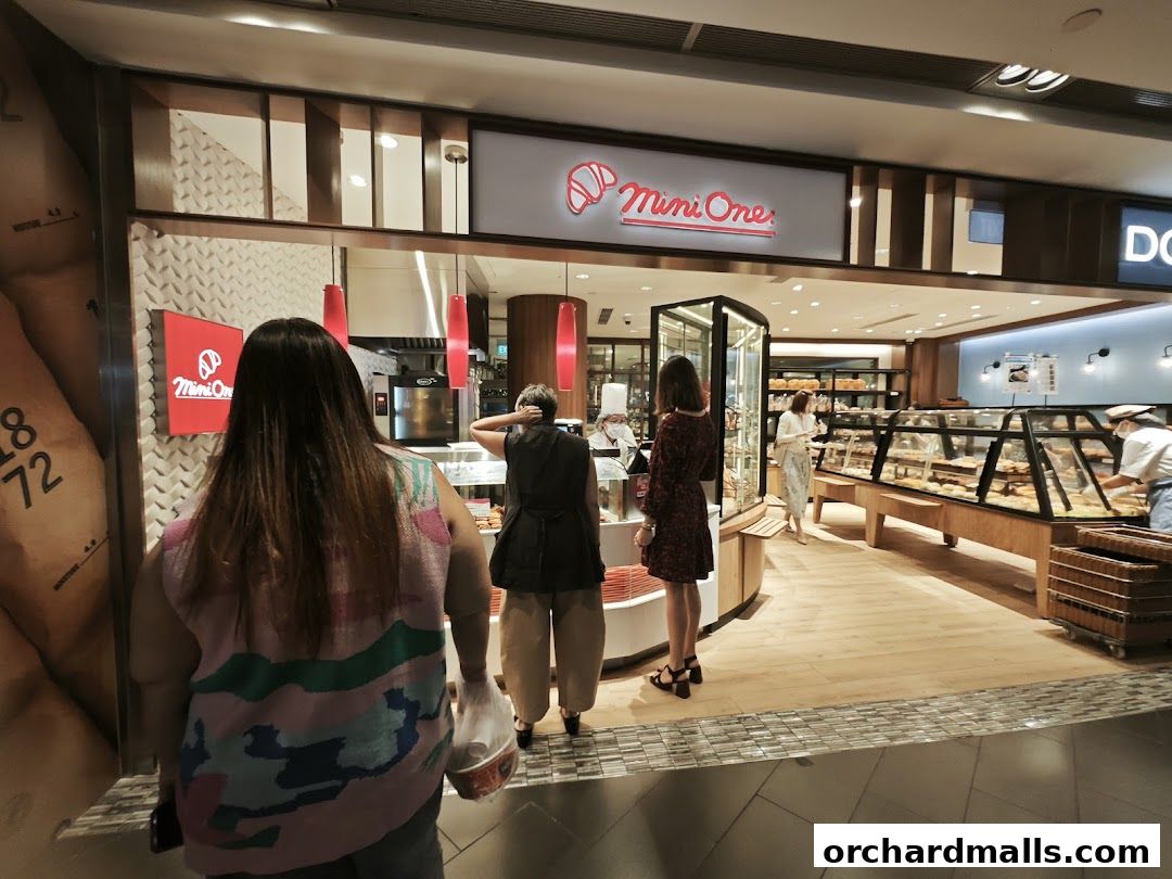 A bakery shop called Mini One with customers browsing baked goods.