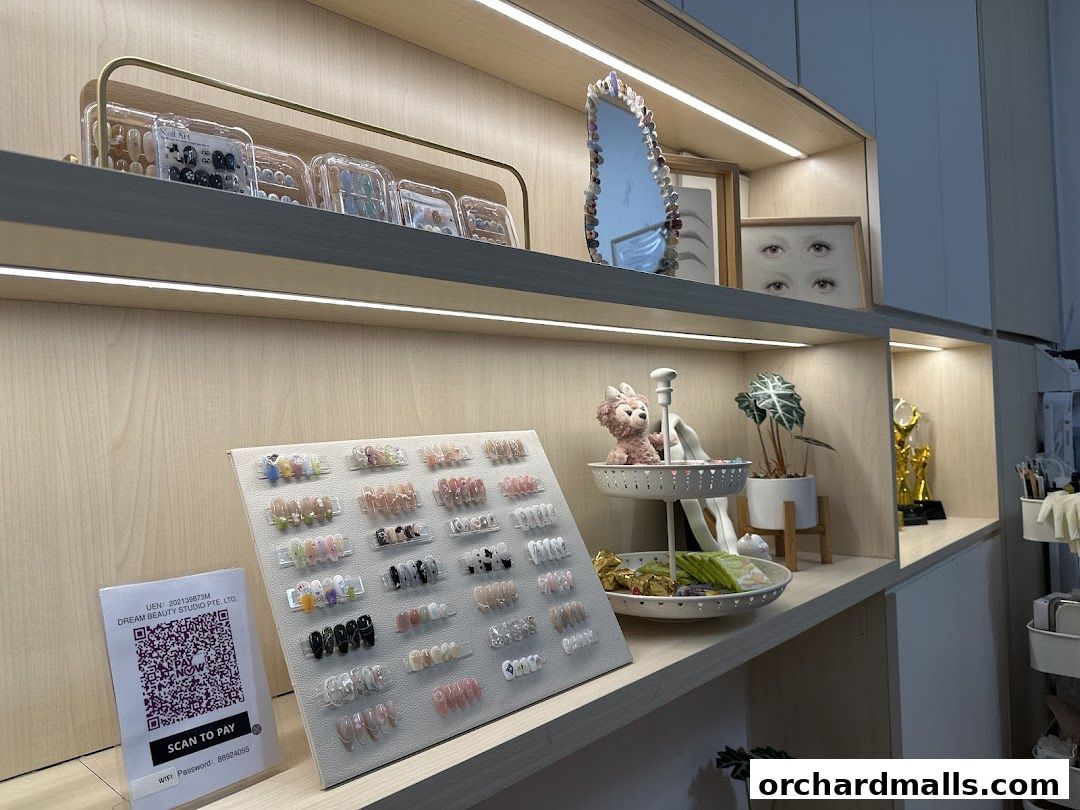 Display of various nail art designs and beauty products at Dream Beauty Studio.