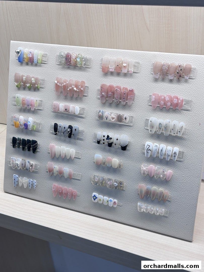 A display of various artificial nails with different designs and colors.