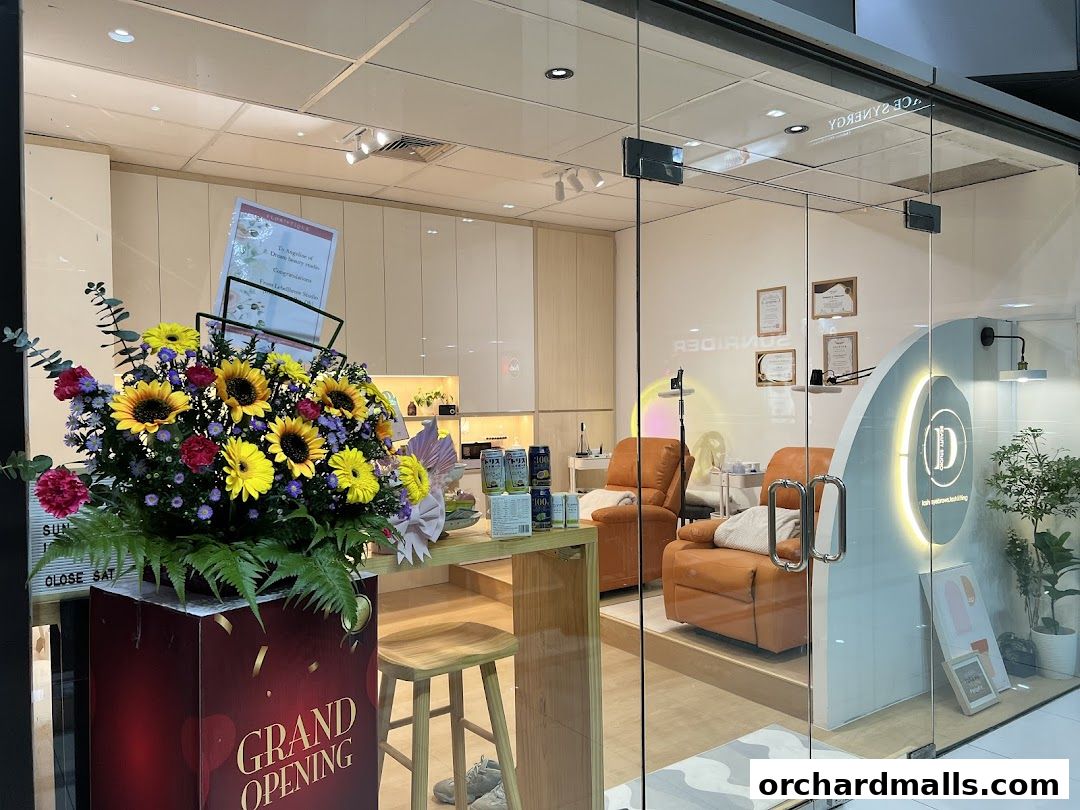 Exterior view of Dream Beauty Studio with a grand opening floral arrangement.