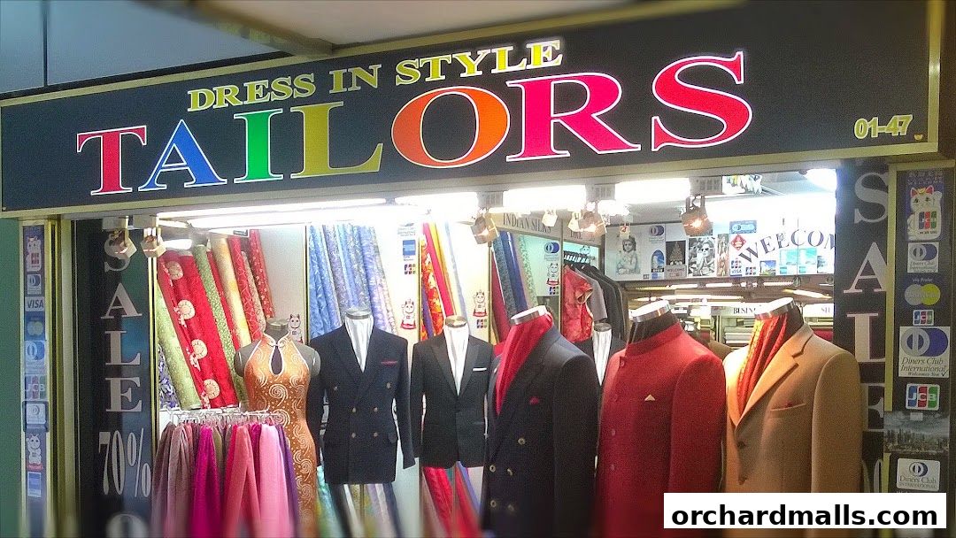 A tailor shop with colorful fabrics and mannequins displaying formal wear.