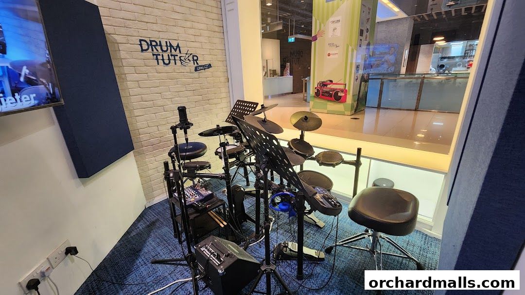 A drum kit setup with a stool and microphone in a music studio.