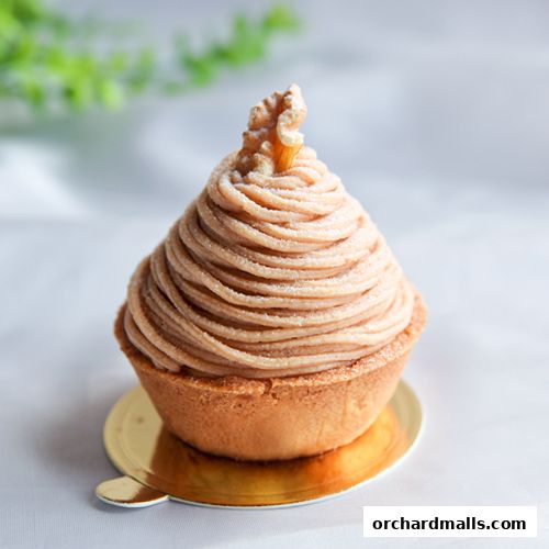 A close-up of a Mont Blanc pastry with a walnut on top.