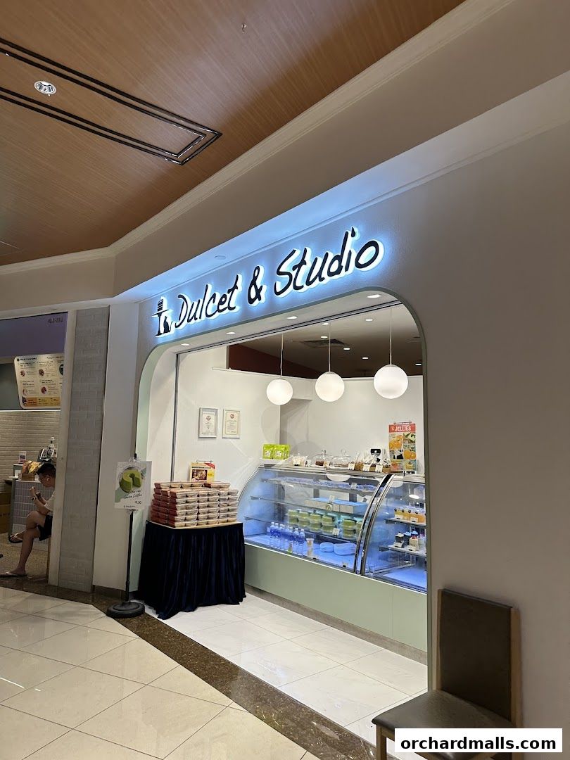 Dulcet & Studio shop front with a display of cakes and pastries in a refrigerated case.