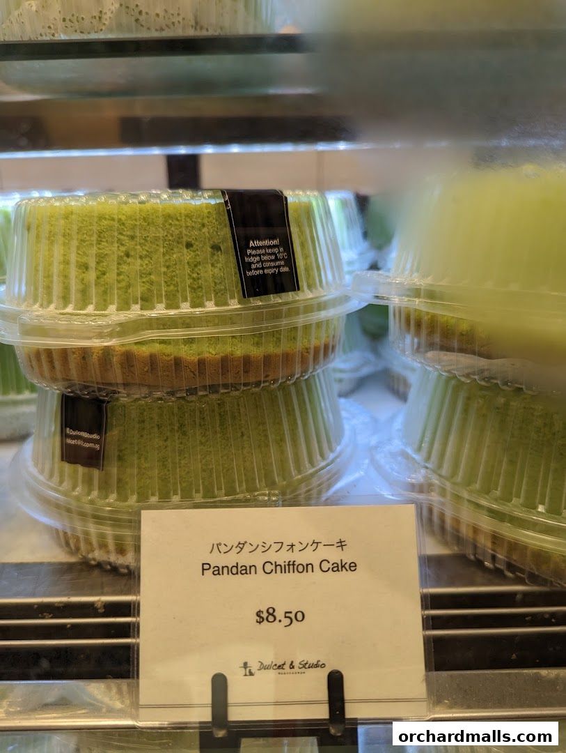 A close-up of a Pandan Chiffon Cake with a price tag and store information.
