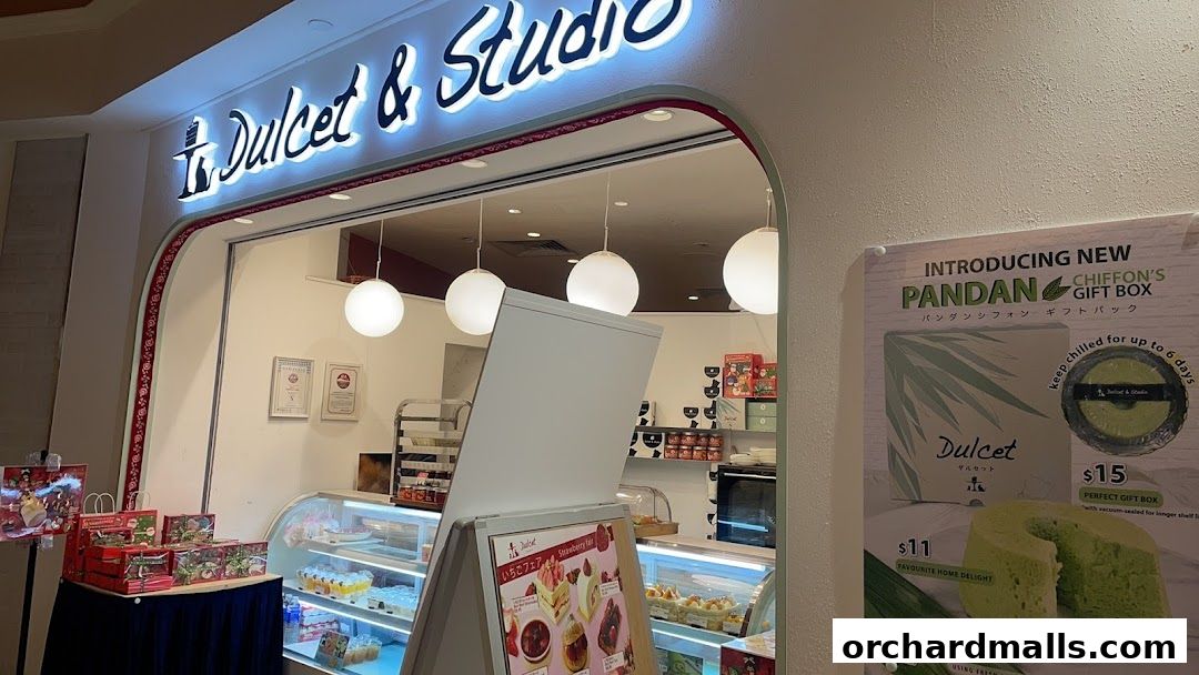 The exterior of Dulcet & Studio, a bakery showcasing cakes and gift boxes.
