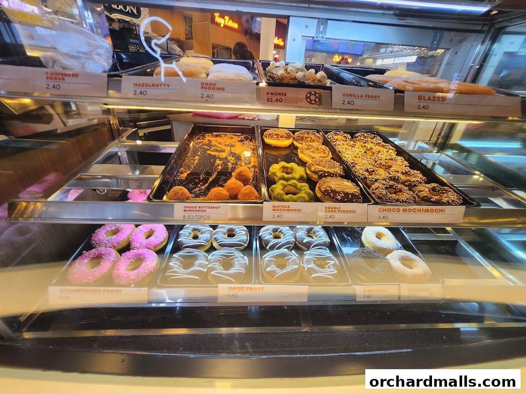 A display case filled with various donuts and pastries at Dunkin'.