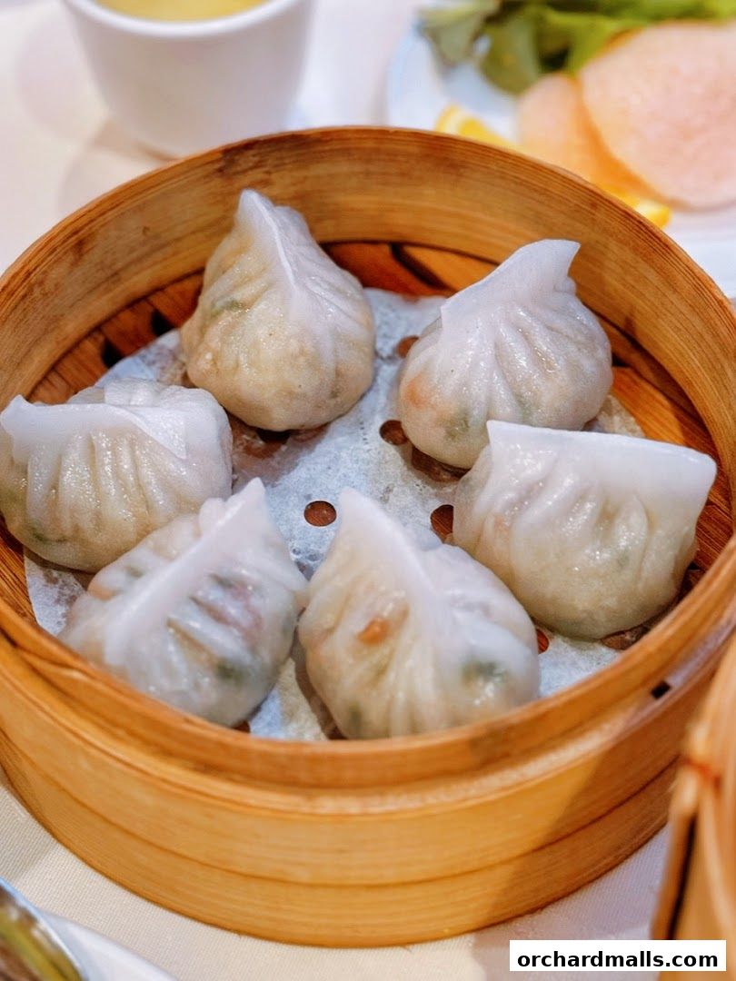 A close-up of steamed dumplings in a bamboo steamer basket.