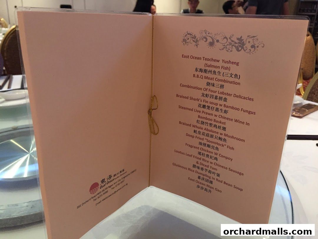 A menu from East Ocean Teochew Yusheng restaurant with various Chinese dishes listed.