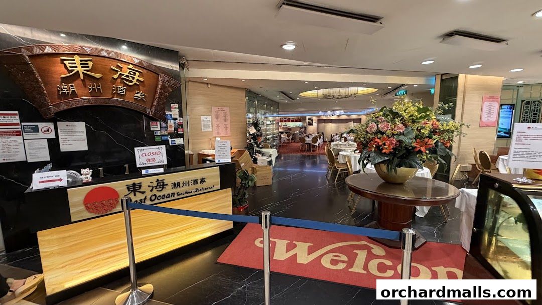 The entrance of East Ocean Teochew Restaurant with a reception desk and dining area visible.