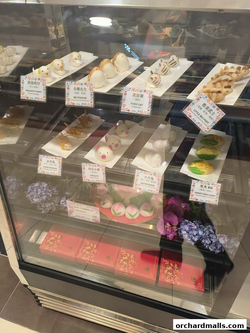 A display case filled with various cute and creatively shaped pastries and desserts.