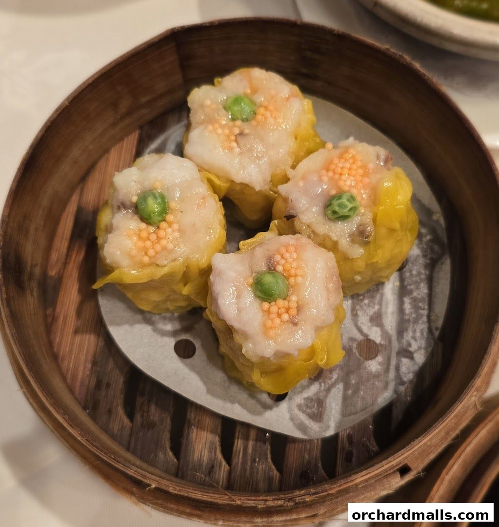 A close-up shot of four delicious shrimp dumplings served in a bamboo steamer.