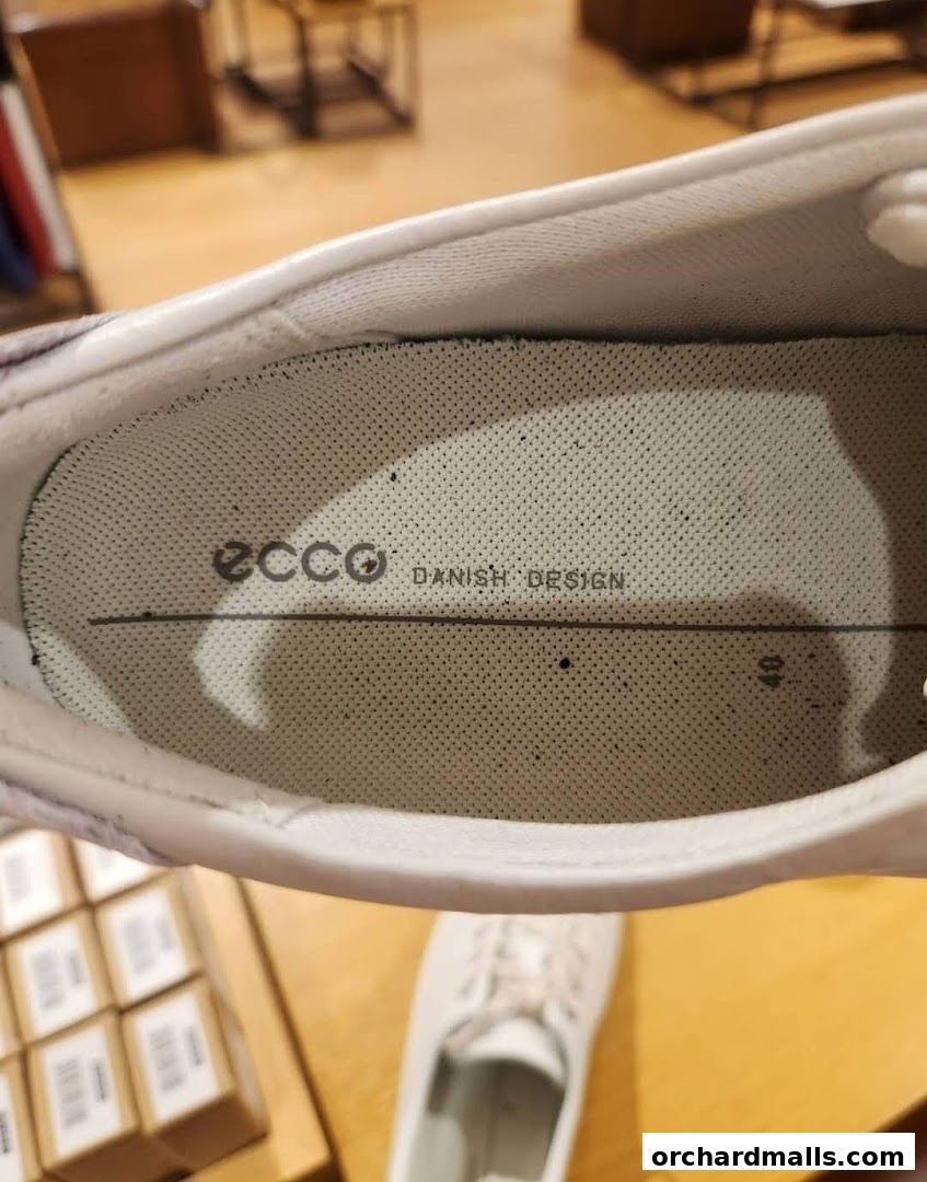 Close-up of the inside of a white ECCO shoe, showing the brand logo and 'Danish Design'.