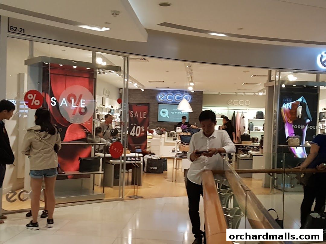 ECCO shoe store with 'SALE' signs and customers browsing inside.
