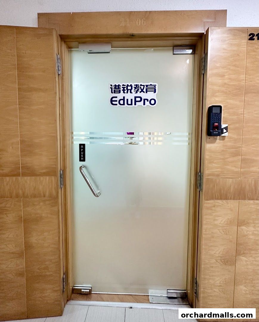 The entrance to EduPro Pte. Ltd., a frosted glass door with company branding.