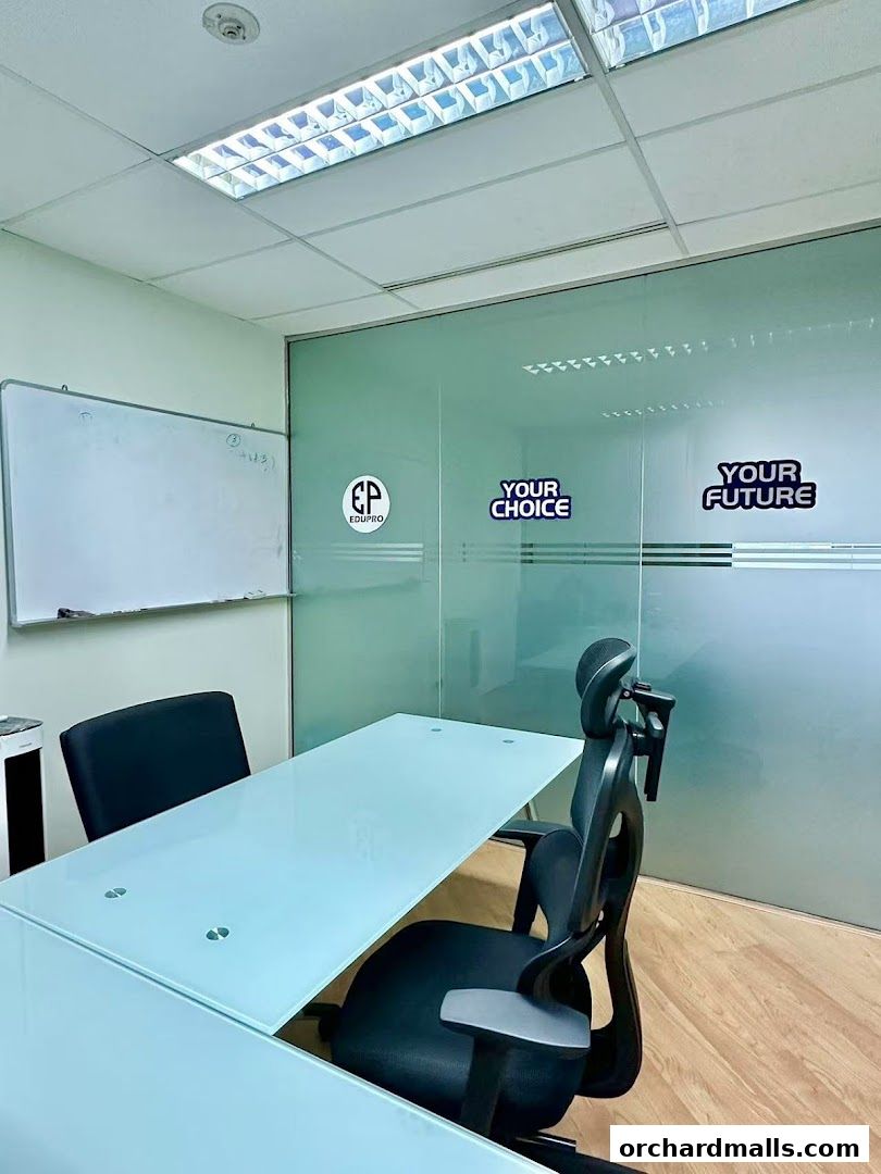 Interior shot of Edupro Pte. Ltd. office with a whiteboard and meeting table.