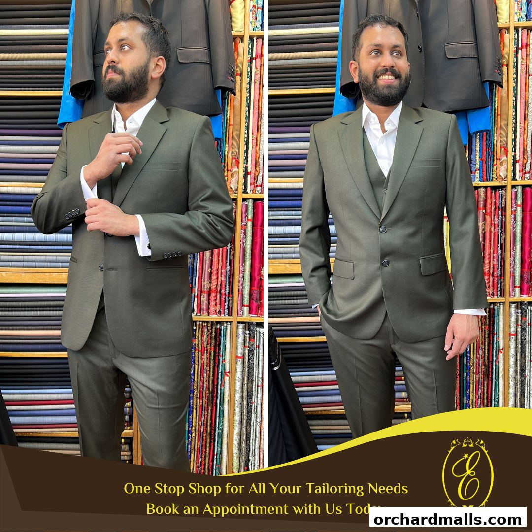 A man models a custom-tailored suit in front of a display of fabrics and suits.