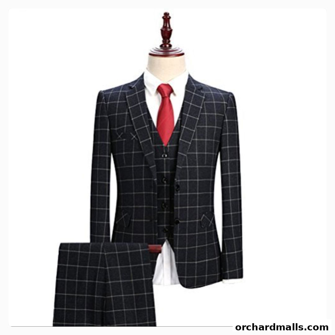 A tailored three-piece suit with a checkered pattern and a red tie displayed on a mannequin.