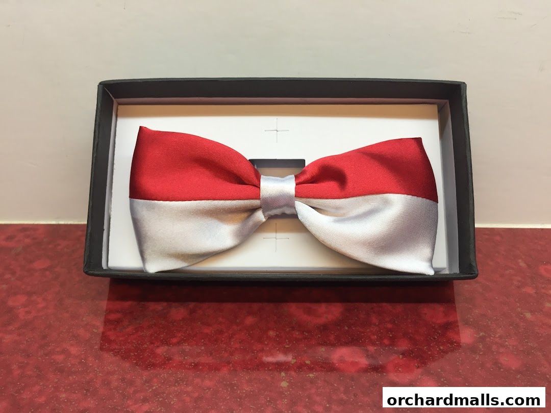 A red and white bow tie is displayed in a black box.