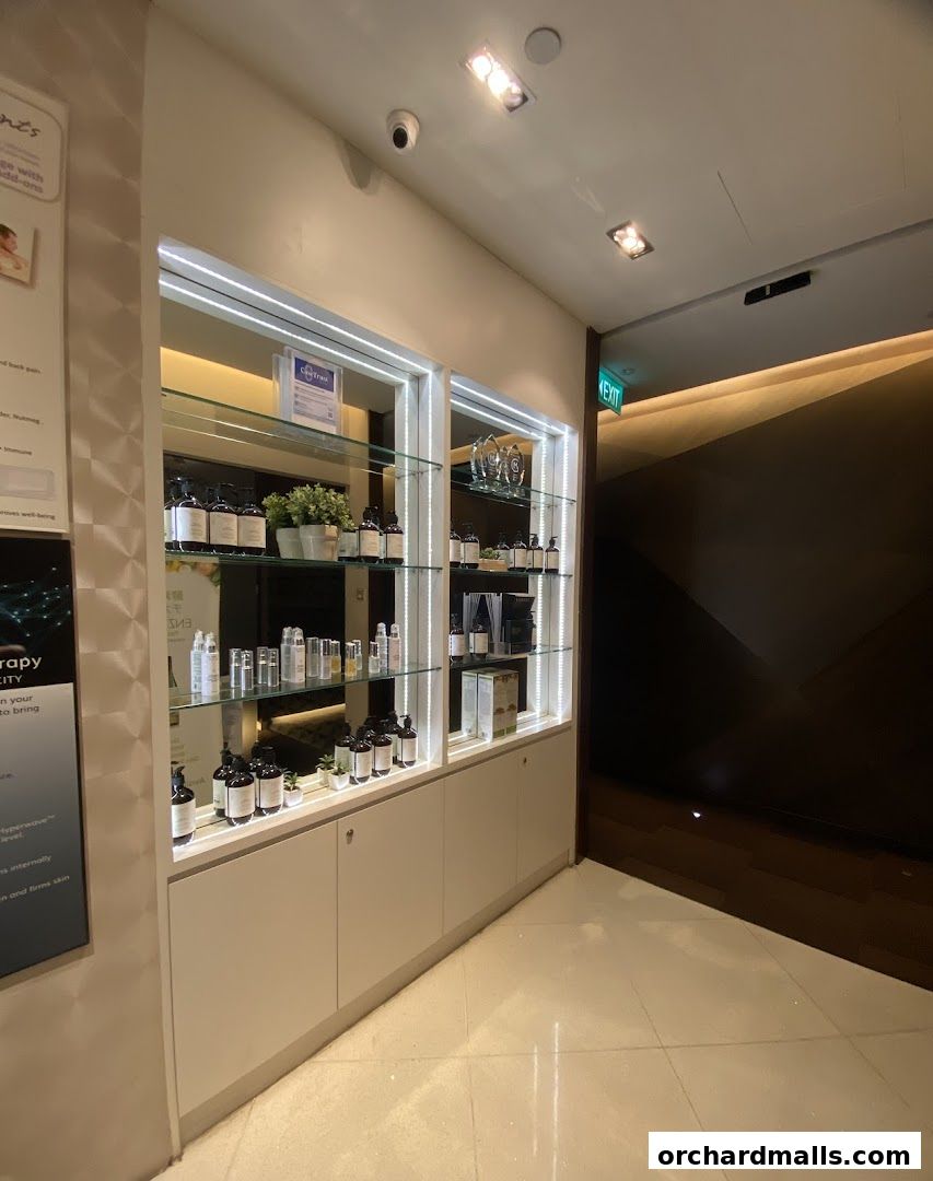 A well-lit display of skincare products in bottles and jars on shelves.