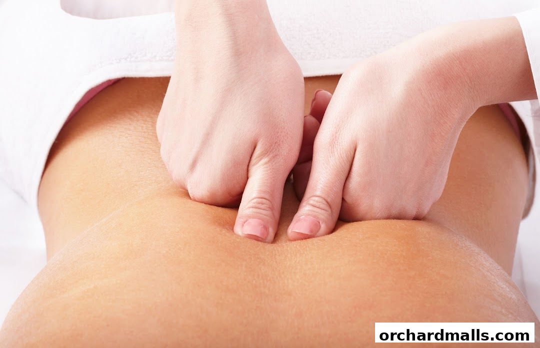 Close-up of hands giving a massage to a person's back.