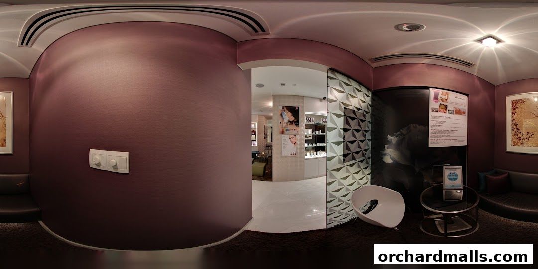 Interior view of a modern spa with treatment posters and seating areas.