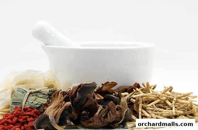 A mortar and pestle with various dried herbs and ingredients for traditional medicine.