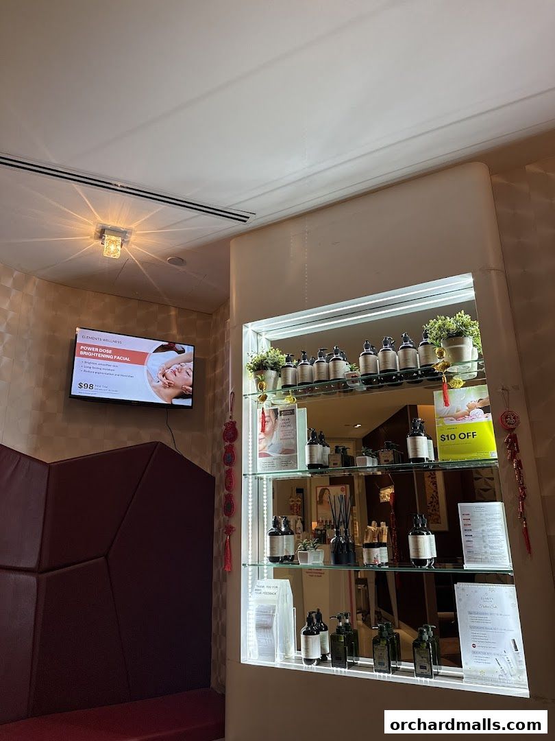 Interior shot of Elements Wellness showing a display shelf with skincare products and a promotional screen.