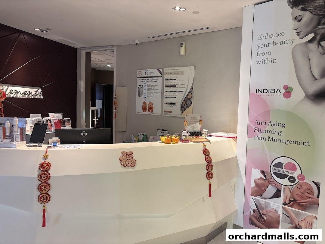 The reception area of Elements spa, featuring a counter with products and promotional banners.