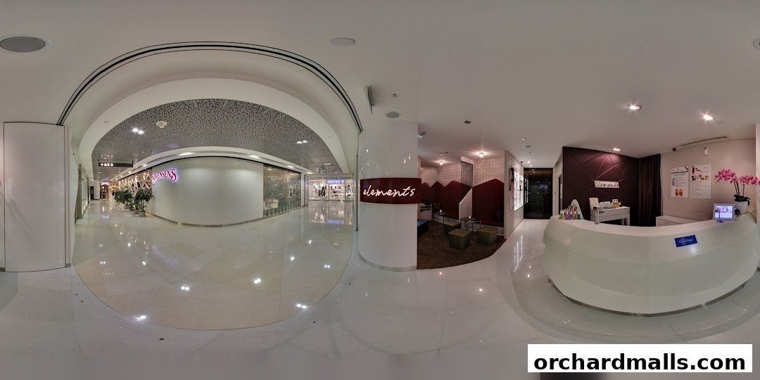 Interior view of the Elements spa reception area with a modern white counter and seating.