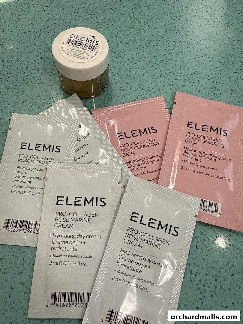 A collection of Elemis skincare samples, including a small jar and several sachets of creams and serums.